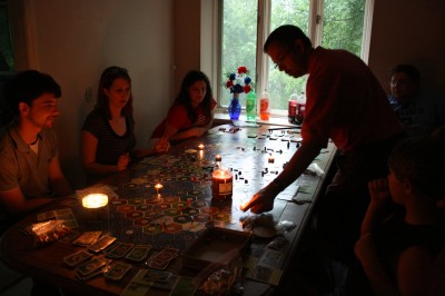 settlers by candlelight after a thunderstorm knocked out the power