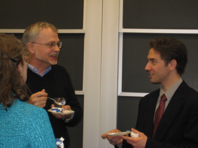 Seth and my Mom talking with his adviser while eating victory cake :grin: 